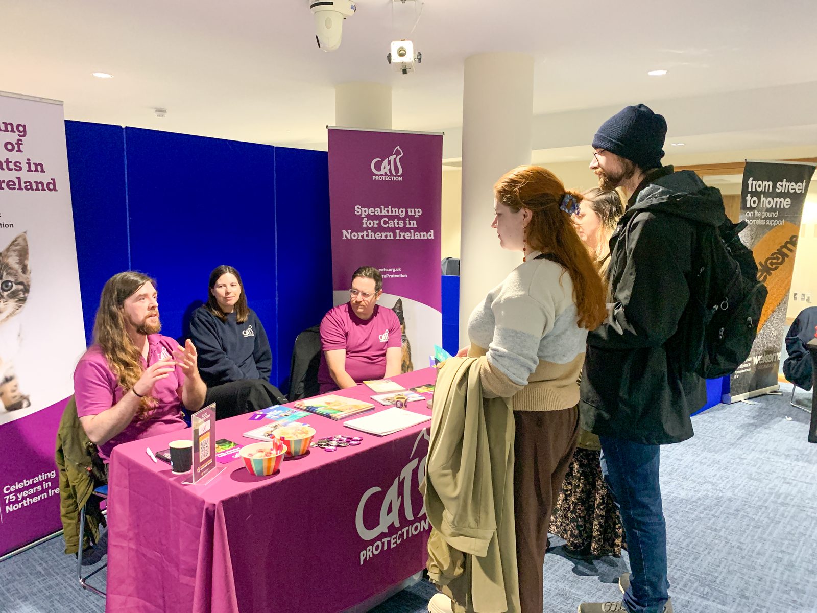 Jobseekers speaking with Cats Protection staff at their stand during the charity careers fair