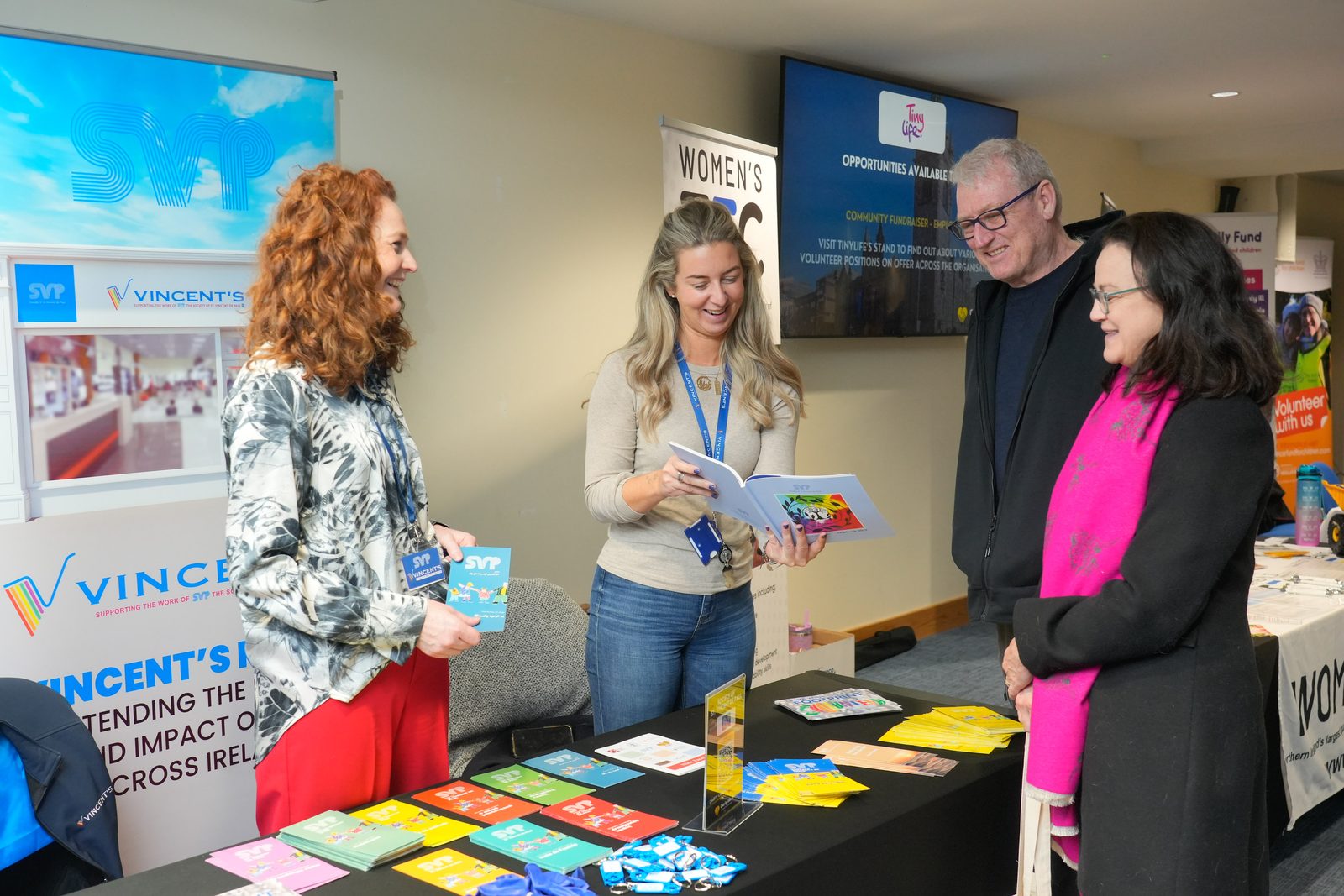Visitors talking with staff at the Vincent's exhibition stand at the charity careers fair